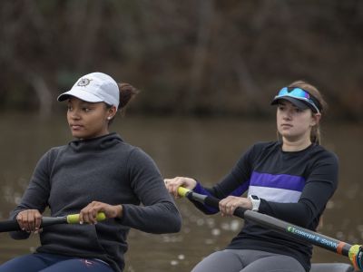 two female rowers on a lake during practice